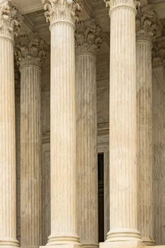 Columns marble Tall vertical facade. Columns architectural symmetry texture Stock Photos