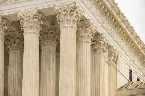 Columns marble Tall vertical facade. Columns architectural symmetry texture.. Stock Photos