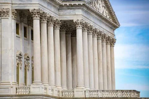 Columns marble Tall vertical facade. Columns architectural symmetry repetit.. Stock Photos