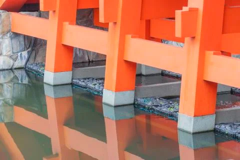 Columns of the red bridge with brook Stock Photos