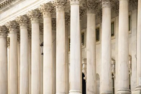 Columns stone facade Tall vertical. Columns fluted marble symmetry pattern... Stock Photos