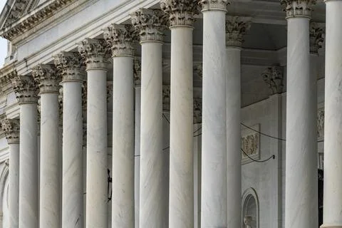 Columns Tall vertical marble facade. Columns fluted symmetry repetition. Co.. Stock Photos