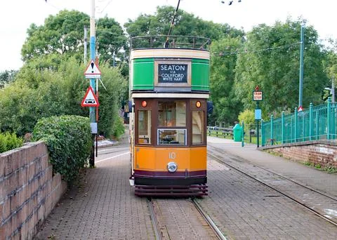 COLYTON, DEVON, ENGLAND - AUGUST 6TH 2012: An orange and green tram sits empt 스톡 사진