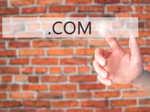 .COM - Hand pressing a button on blurred background concept on visual screen. Stock-Fotos