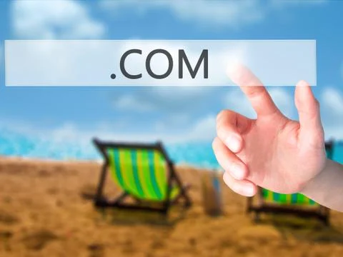 .COM - Hand pressing a button on blurred background concept on visual screen. Stock Photos