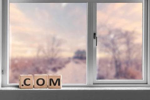 Com sign in a bright window with a view Stock Photos