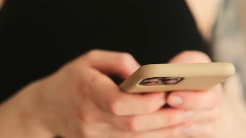 Цoman typing message on mobile phone or downloading an app Stock Footage 149117088