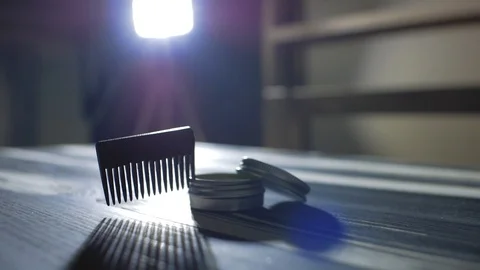 Comb for beard and mustache lies near the wax.barber accessories Stock Footage 102942489