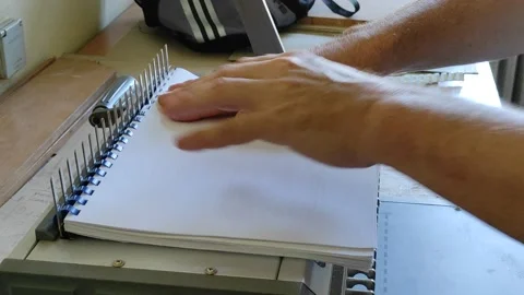 Comb binder machine with clipping path	 Video stock 137507874