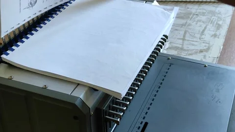 Comb binder machine with clipping path	 Video stock 137507933