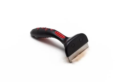 Comb for combing wool from animals on a white background Photos