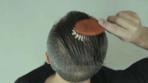 Comb Man combing hair, hiding Stock Video Pond5