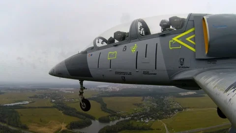 Combat aircraft flies with open, released landing gears against dark cloudy sky. Stock Footage 118677070