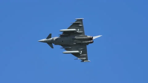 Combat aircraft in flight at low speed high angle of attack at full afterburner Stock Footage 168070069