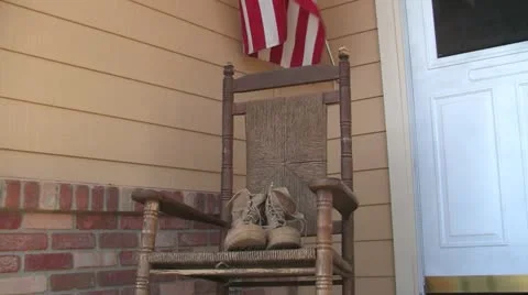 Combat boots on porch right to left trucking shot Stock Footage 10862346