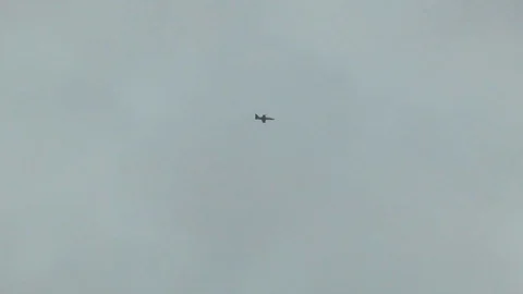 Combat fighter plane make barrel roll maneuver against a cloudy sky. Dangerous. Stock Footage 118677475