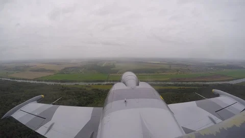 Combat gray fighter plane flies against a dark overcast cloudy sky. Top view. Stock Footage 118677268