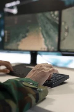 Combat IT engineer supervising and assisting team members in the field 库存照片