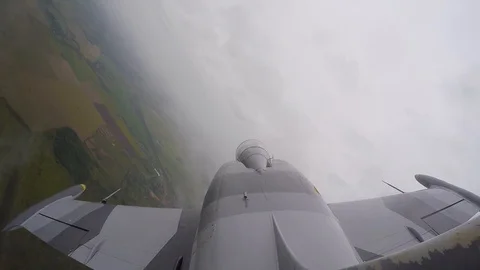Combat jet fly through white thick clouds. Fighter is tilted to left and flies. Stock Footage 118677348