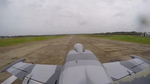 Combat jet plane starts, accelerates along runway and takes off.  View from tail Stock-Footage 118677215