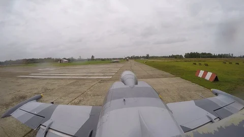 Combat plane come out for the runway against fields. Top view from tail fin. Stock Footage 118677174
