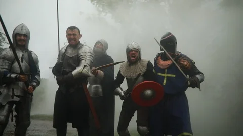 Combat squad of medieval knights stands in armors and runs to attack. Stock Footage 109490236
