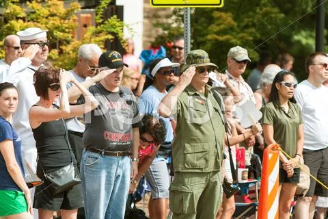 Combat Veterans Salute American Flag At Old Soldiers Day Parade Stock Photos