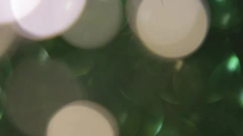 A combination of fixed golden lights and moving bright green bokeh Vidéo 317487490