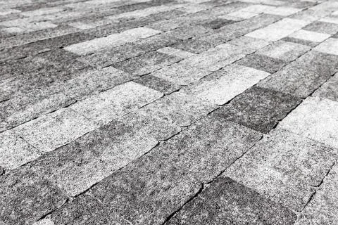 A combination of light and dark paving slabs of different sizes. The paving i Stock-Fotos