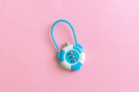 Combination lock on light pink background. Password sign. Close up, top view Stock Photos
