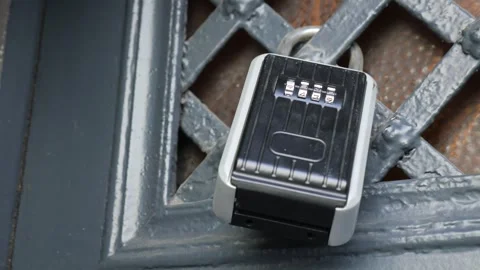Combination lock on metal gate for secure access key safe box footage. Stock Footage 332323943