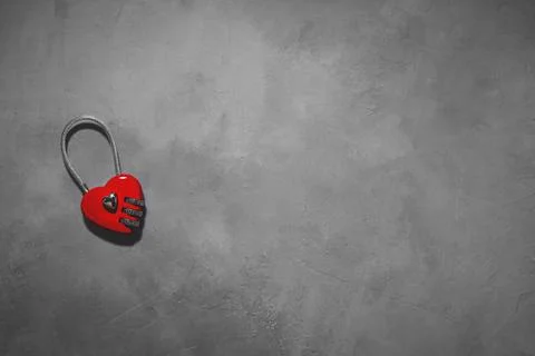 Combination lock in the shape of a heart on a gray background. key to the hea Stock Photos
