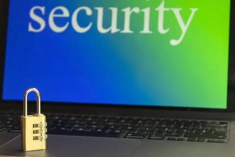 Combination padlock on laptop keyboard with security text on screen Stock Photos