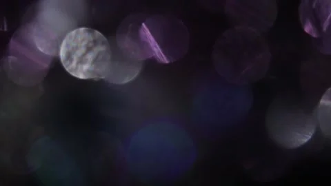 Combination of rainbow bokeh lights and fixed purple in black Vídeo Stock 317449863