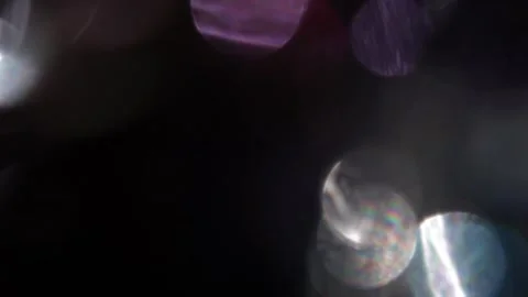 Combination of rainbow bokeh lights and fixed purple in black Vídeo Stock 317449895