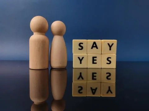The combination of the SAY YES message with two wooden figures and their re.. Stock Photos