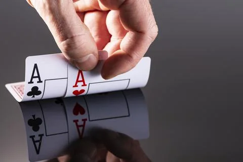 A combination of two aces is reflected on the surface of a black background a Stock Photos