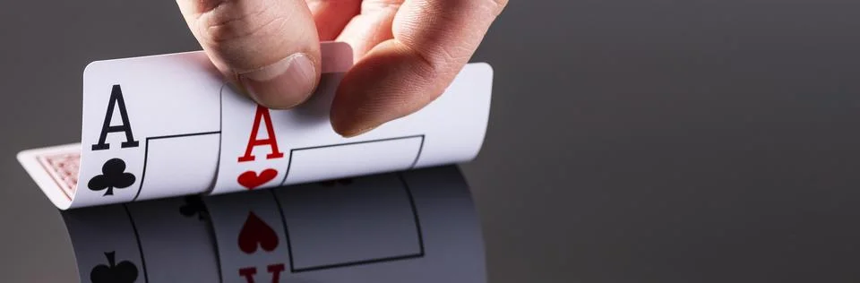 A combination of two aces is reflected on the surface of a black background a Stock Photos