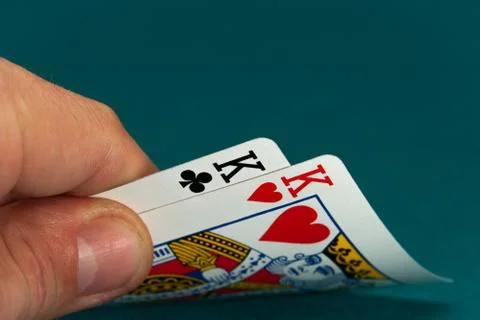 Combination of two different play cards in a hand Stock Photos