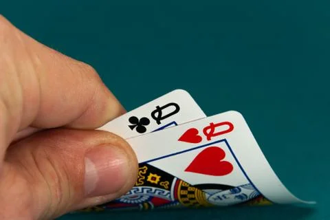 Combination of two different play cards in a hand Stock Photos