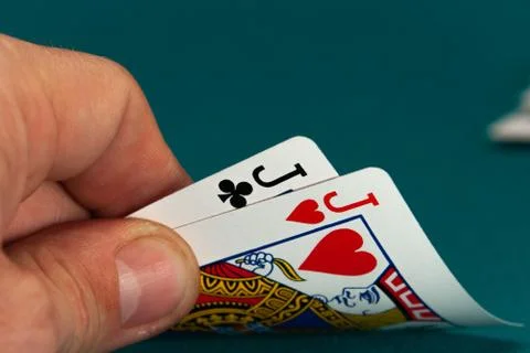 Combination of two different play cards in a hand Stock Photos