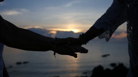 Combine friends, stack each other's palms against the sunset at the sea. HD Stock Footage 91869625