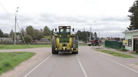 Combine harvester and tractors are driving on the road Stock Footage 145680153
