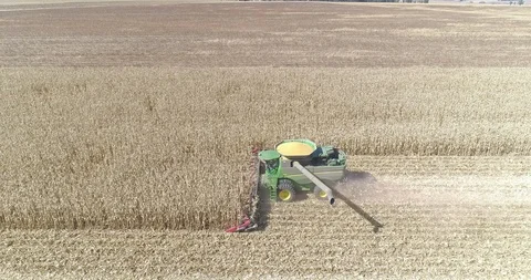 Combine harvester extending its unloading auger to point directly at camera Video stock 93819861