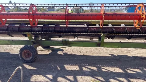 A combine harvester pulls a trailer with a mower Stock Footage 219650129