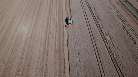 Combine harvester on wheat fields from Top Front Zoom IN Aerial View Video stock 204984597