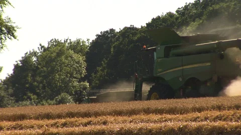 Combine Harvester working in a barley field in England 動画素材 106085196