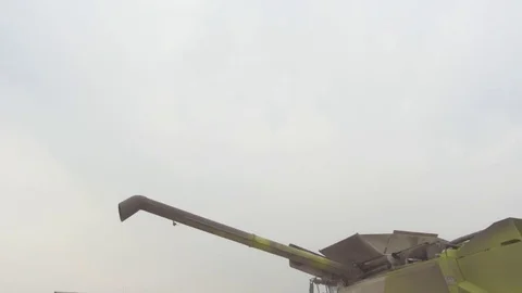 Combine with the screw pipe in a field Stock Footage 82288087