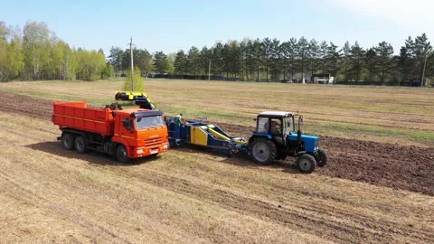 Combine unloads a filled harvesting Stock Footage 218019486