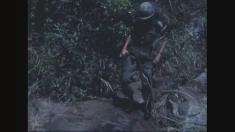 Combined forces moving thru dense jungle - 1970 Stock Footage 98989122